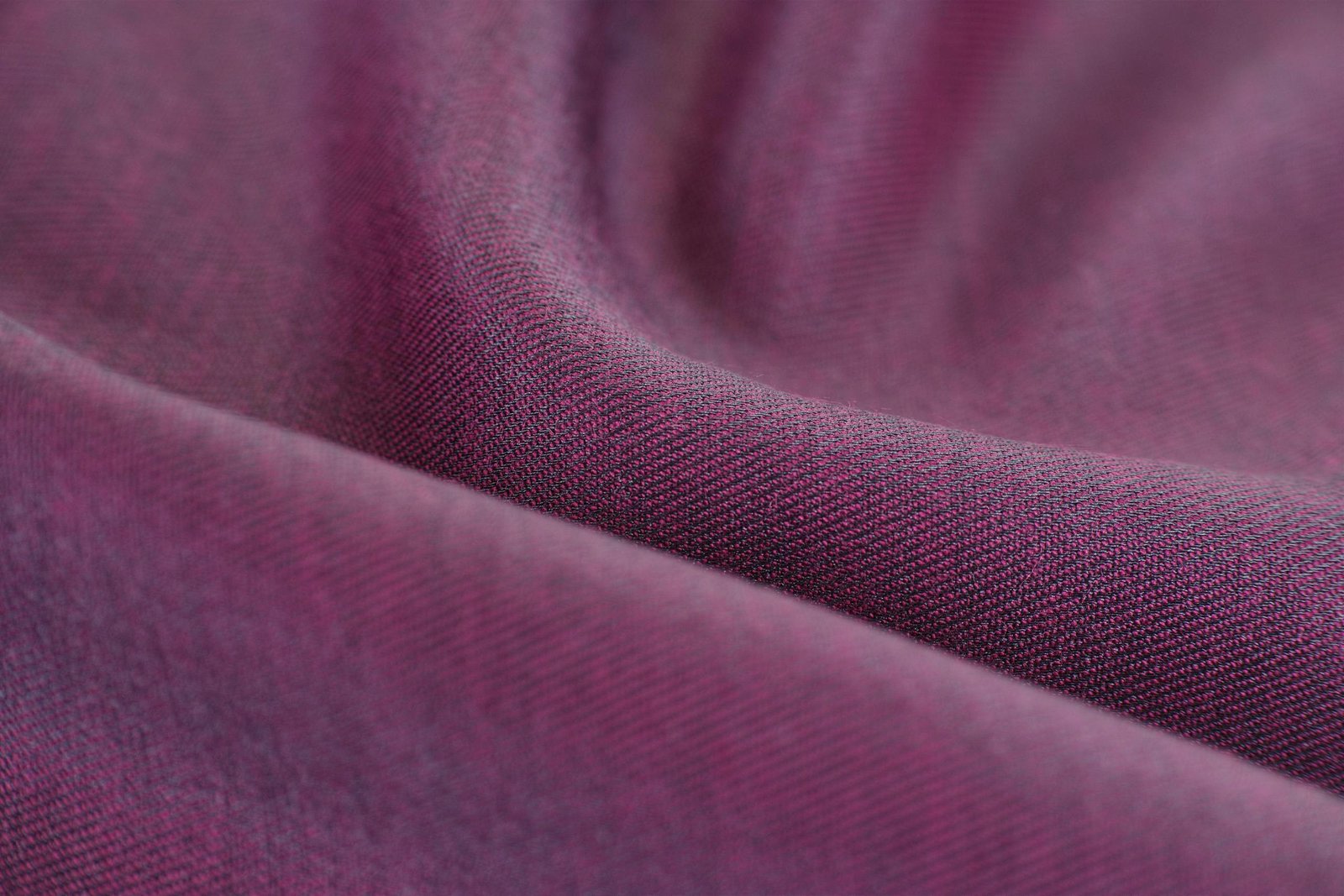 Detailed close-up of purple fabric showcasing its rich texture and softness.